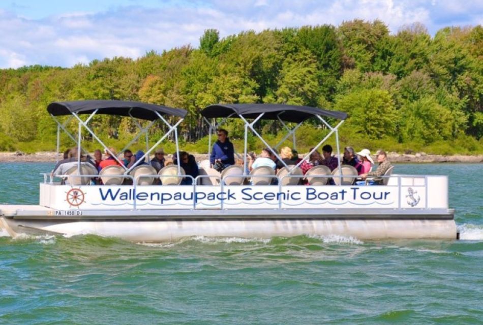 A group of people in a pontoon boat on a scenic tour of a lake